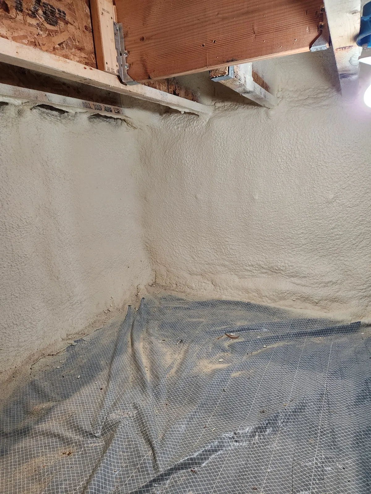 Rim joist sealed with closed-cell spray foam, an example of the work Peak Insulation provides for homes and shops in the Kalispell, Montana service area