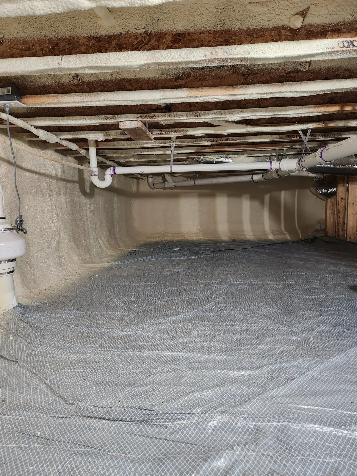 Closed-cell foam and vapor barrier in a crawl space, an example of the work Peak Insulation provides for homes and shops in the Eureka, Montana service area